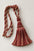 A decorative tassel with a knotted cord loop, featuring striped red, beige, and brown threads, set against a plain light gray background.