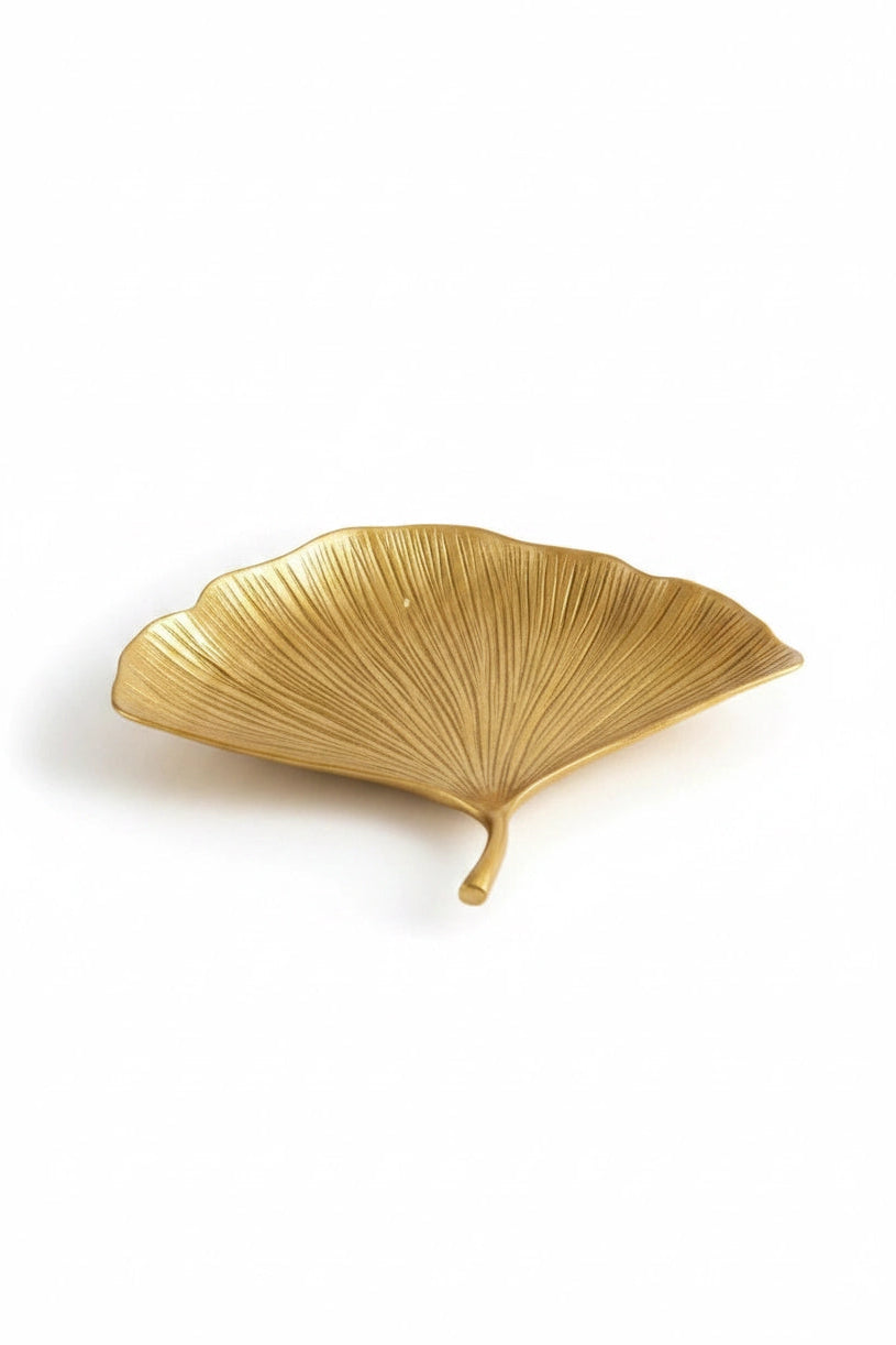 A gold leaf-shaped decorative tray with a textured, ribbed surface, shown on a clean white background.
