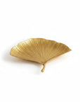 A gold leaf-shaped decorative tray with a textured, ribbed surface, shown on a clean white background.