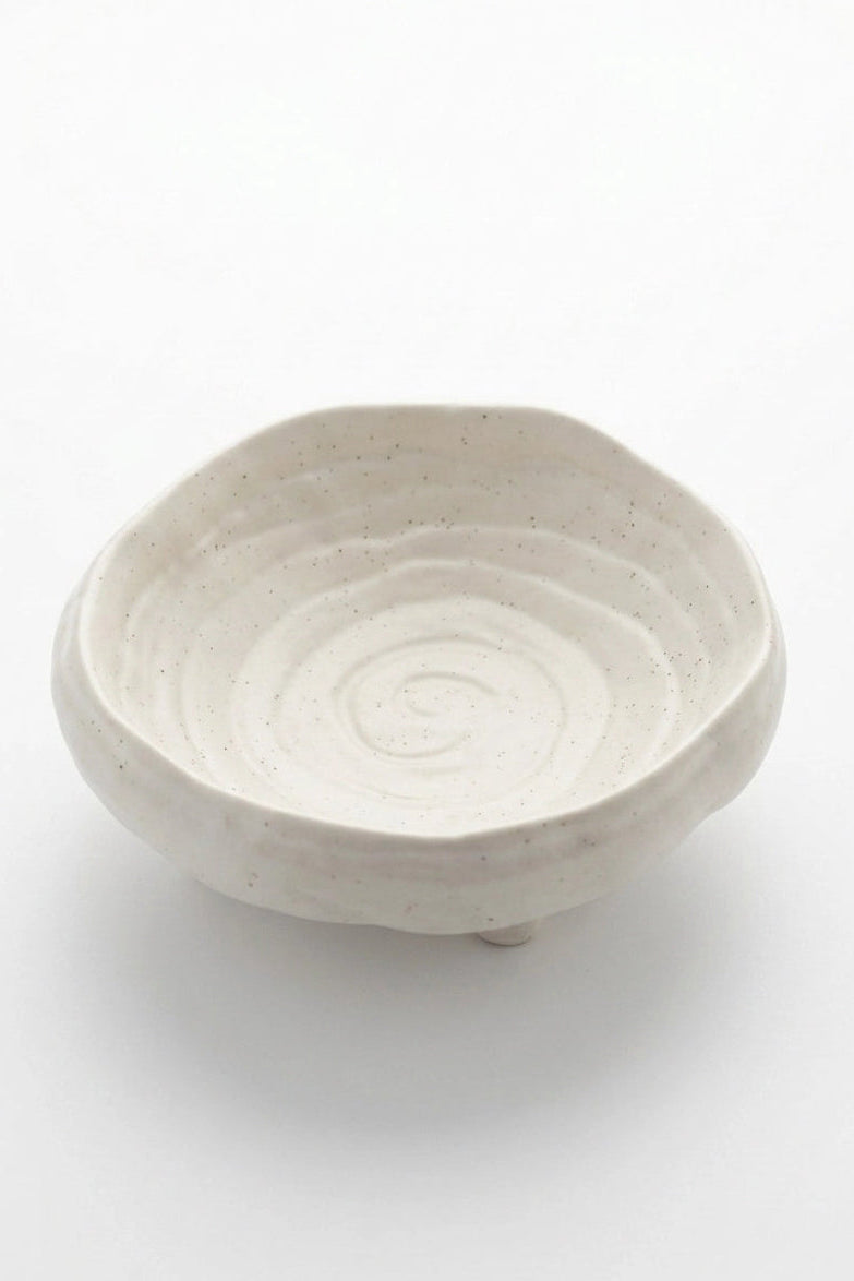 White ceramic bowl with spiral design on a white background
