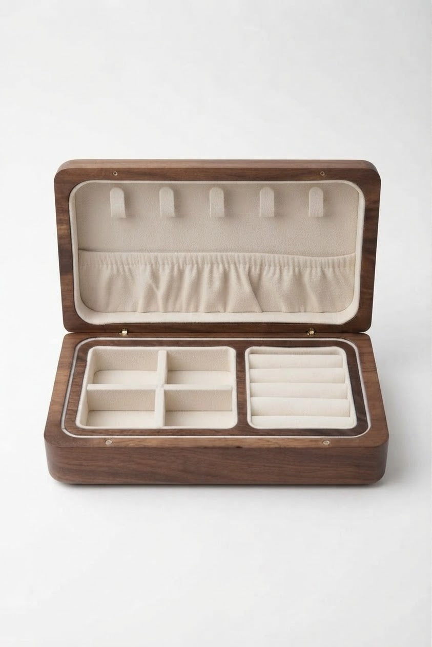 An open wooden jewelry organizer box with a dark brown wood exterior and cream-colored interior compartments, photographed on a clean white background.