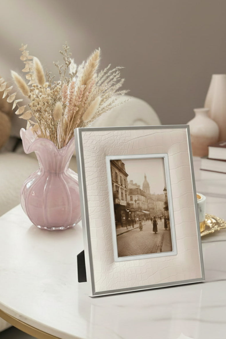 Decorative setting with a luxury framed , pink glass vase with dried flowers.