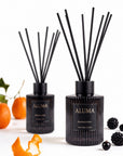 Aluma Blackberry & Bay reed diffuser 110ml — dark glass bottle with reeds, styled with orange, blackcurrant and blackberry