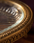 Close-up of the hand-finished brass rim and glass surface of the Athena Tray
