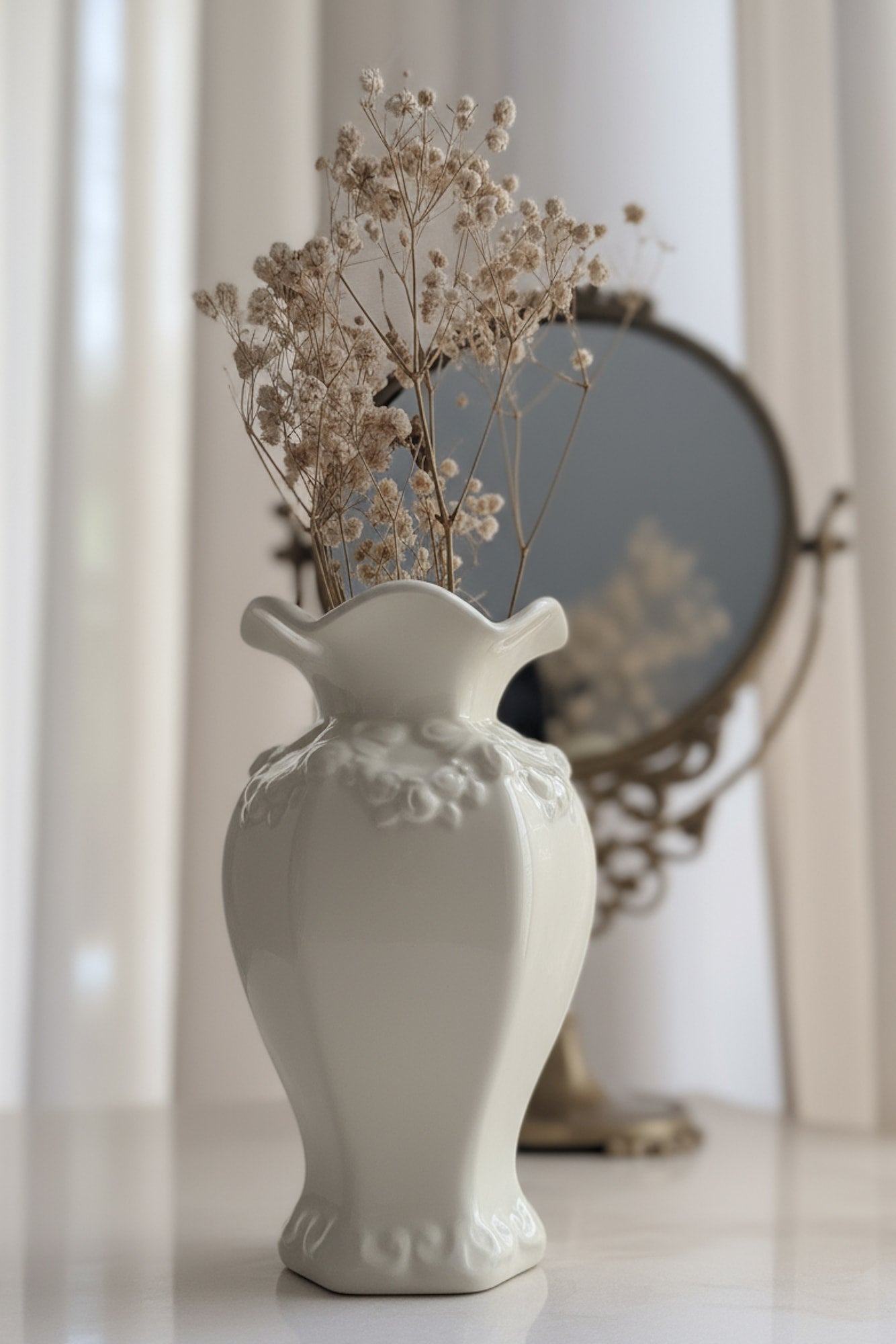 White decorative vase with floral patterns on a light background